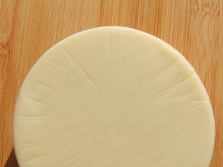 Wall Mural - Piece of cheese on a wooden background