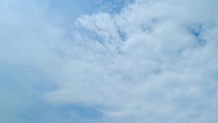 Wall Mural - Soft white clouds moving on blue sky background. Tropical summer or spring sunlight. Daytime. Time lapse.