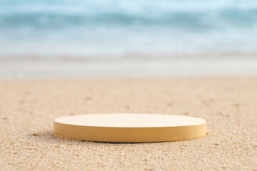 Empty round beige platform podium on the beach sand.