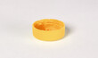 © michaklootwijk - Isolated yellow plastic cap - Concept of pollution