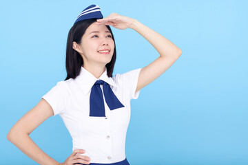 airplane stewardess young woman looking far away isolated on blue background