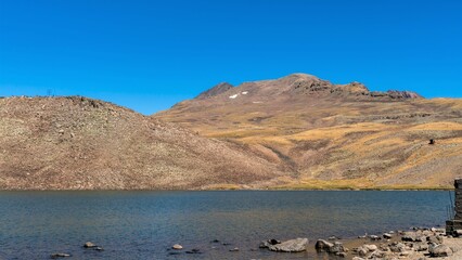 Wall Mural - View of an alpine lake in the Caucasian mountains, autumn.