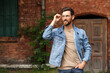© New Africa - Handsome bearded man with glasses looking away outdoors. Space for text
