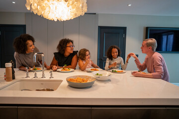 Family enjoying dinner in kitchen