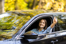 Young Woman Inside A Car Driving In The Street And Gesturing Thumb Up