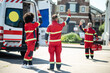 © zinkevych - Ambulance doctors in the red uniforms greeting each other outdoors