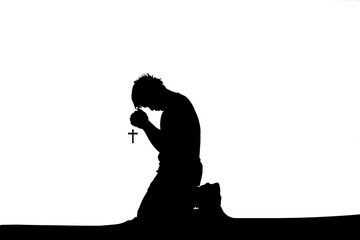Wall Mural - Silhouette of a lonely, desperate Christian man sitting and praying to God. hopeful