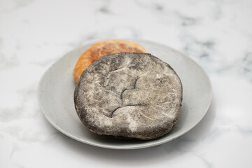 Poster - healthy small bread with carob and spices on dish