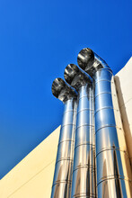 Low Angle View Of Pipes Against Clear Blue Sky