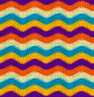 Seamless crochet zigzag pattern is crocheted with bright contrasting threads. Acrylic baby yarn. African style.