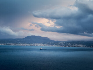 Wall Mural - Ship on seascape against cloudy sky