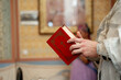 © Tsakno - The Bible is in the hands of a priest in the church.Preparation for the ceremony