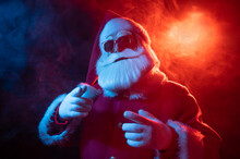 Portrait Of Santa Claus In Sunglasses In Neon Light.