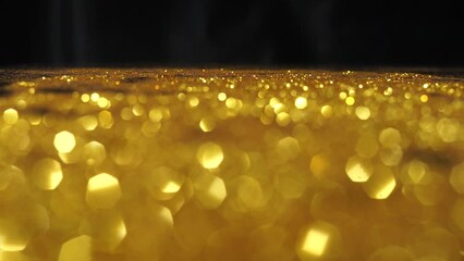 Wall Mural - Abstract golden texture in blurry light for background animation. Glitter pattern for video effect, transition and overlay