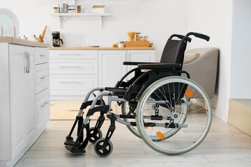 Modern empty wheelchair in kitchen