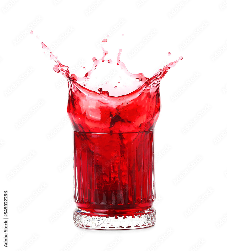 Glass of fresh pomegranate juice with splashes on white background