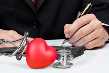 Poster - Doctor writing and medical stethoscope on the desk