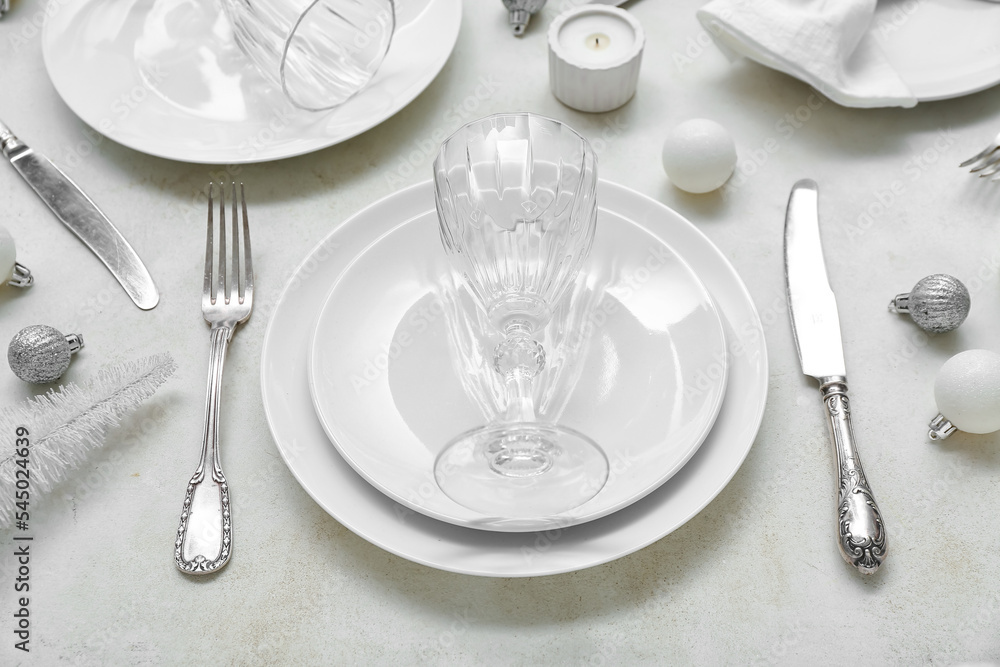 Beautiful table setting with Christmas balls on white background, closeup