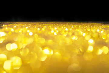 Wall Mural - Abstract golden texture in blurry light for background. Glitter pattern for photo effect and wallpaper