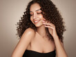 Beautiful smiling woman with afro curlsFashion studio portrait of beautiful smiling woman with afro curls hairstyle. Fashion and beauty