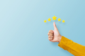 man hand showing thumb and giving a five star rating. service rating, feedback, satisfaction concept
