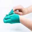 © Austockphoto - Safely removing green surgical gloves
