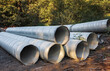 Stormwater pipes. Large Corrugated Metal Culvert Pipes in Field. Flexible corrugated aluminum tubes