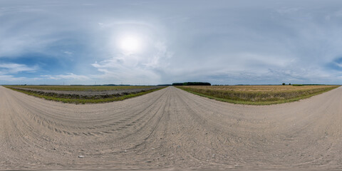 Wall Mural - full seamless spherical hdri 360 panorama view on no traffic gravel road among fields with overcast 