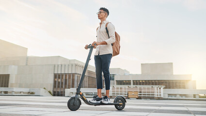 Wall Mural - Man on scooter for travel, eco friendly transport and urban with environment and sustainability on commute to work. Young hipster, electric scooter and clean carbon footprint motivation in cityscape.