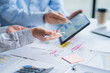 © Kritdanai - Group of business people meeting together Pointing to the graph assess business profits.