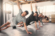 © N F/peopleimages.com - Fitness, exercise and training with a sports group stretching together in gym class for health or wellness. Workout, diversity and coach with a team warmup in a sport facility for performance