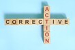 Corrective action business concept.  Wooden blocks crossword puzzle flat lay.