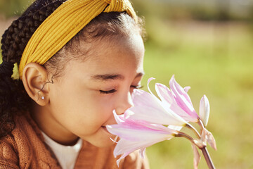 nature, beauty and child smell flower in park, enjoying weekend, holiday and vacation in countryside