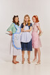 © Lustre Art Group  - Portrait of elegant young women posing with knives isolated on grey background. Movie remake