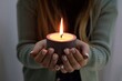 © Anna - person hands holding a fired candle, keeping fire, concrete soy vegan candle