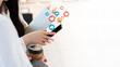 © ic36006 - The concept of social medias and technology.Close up hands using smartphone addiction to technology trends following and chatting with icons on social networks. surrounded by many icons, likes, hearts