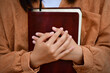 © Kalawin - young woman hugging bible and praying to god. Christian Concepts.