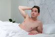 © Евгений Шемякин - Young surprised wondered man wake up in bed in bedroom in the morning