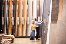 Senior Male And Female Customer Buying Laminated Wooden Boards At Hardware Store