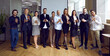 © Studio Romantic - Team of happy business people standing in office and clapping hands. Diverse group of employees applauding after successful presentation, conference, coaching event, workshop or seminar