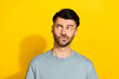 © deagreez - Portrait photo of young funny guy bearded pouted lips looking empty space advertisement unsure information distrust isolated on yellow color background