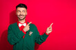© deagreez - Portrait of classy near young man toothy smile look indicate fingers empty space isolated on red color background