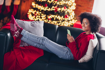 Sticker - Photo of cute adorable cheerful child wear red sweater sitting couch use gadget enjoy xmas atmosphere room house indoors