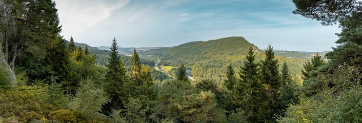 Sticker - Beautiful forest landscape with lush fir trees and mountains in Scotland