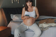 © ikostudio - Pregnant woman calling medical assistance