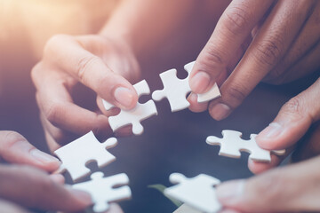 business strategy ideas Business team planning a strategic meeting Assembling jigsaw pieces, using jigsaw puzzles, showing solutions for business people, teamwork.	
