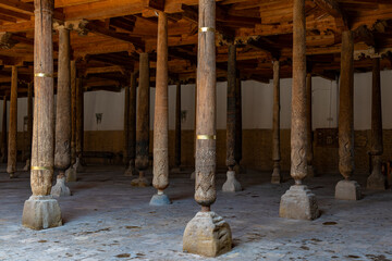 Wall Mural - Ancient carved wooden columns in the medieval Juma mosque. Khiva, Uzbekistan