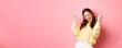 © Mix and Match Studio - Girl screams with joy and fist pump, say yes, achieve goal or success, celebrating achievement, triumphing and winning, standing over pink background