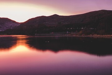 Poster - Mesmerizing pink sunset over a lake - great for a background