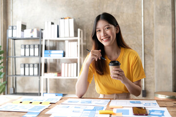 Young asian designer woman drawing a website outline and website ux app development on mobile phone.